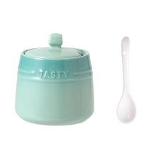 Load image into Gallery viewer, Gradient Colored Seasonings Jar by Allthingscurated come equipped with spoons for convenient access to their contents during cooking and dining. Made from high-quality porcelain, their vibrant colors in gradient tones and stylish design will add a pop of color to your kitchen or dining table, while keeping your herbs, spices and seasonings neatly stored and organized. 8 tasty colors to choose from. Featured here is jar in green.