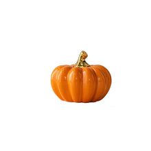 Load image into Gallery viewer, Glazed Ceramic Pumpkins by Allthingscurated spot a sculptural design that are perfect for adding a chic and stylish touch to your Halloween and Thanksgiving celebrations. Available in two designs in orange or white, let these ornamental pumpkins transform your home into a cozy autumn oasis. Featured here is the Short Pumpkin in Orange.