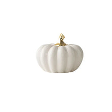 Load image into Gallery viewer, Glazed Ceramic Pumpkins by Allthingscurated spot a sculptural design that are perfect for adding a chic and stylish touch to your Halloween and Thanksgiving celebrations. Available in two designs in orange or white, let these ornamental pumpkins transform your home into a cozy autumn oasis. Featured here is the Short Pumpkin in white.