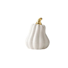 Load image into Gallery viewer, Glazed Ceramic Pumpkins by Allthingscurated spot a sculptural design that are perfect for adding a chic and stylish touch to your Halloween and Thanksgiving celebrations. Available in two designs in orange or white, let these ornamental pumpkins transform your home into a cozy autumn oasis. Featured here is the Tall Pumpkin in white.