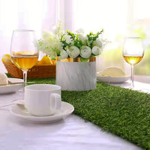 Load image into Gallery viewer, Faux Grass Table Runner by Allthingscurated is the perfect decorative piece to spice up your table settings for spring, summer and easter.  Featuring tufted grass for a realistic look, this runner is a must-have for garden-themed gatherings or outdoor parties. You can also decorate your patio and balcony with this fun and versatile decorative piece for a touch of nature indoor. Comes in 3 different sizes.