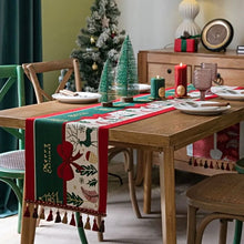 Load image into Gallery viewer, Holiday Bow and Elk Table Runners by Allthingscurated are inspired by all the notable symbols of Christmas like the merry bow, Christmas tree, elk and snowflakes. The jacquard table runners come in vibrant hues of blue and green with beautiful embroidery and complete with pretty tassels. Available in 9 sizes. They are perfect holiday decoration to bring a festive touch to. Your table setting.