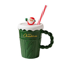Load image into Gallery viewer, Snow Capped Christmas Gift Mug by Allthingscurated boasts festive colors of red, green and white, featuring a Merry Christmas greeting engraved on the mug. The elegant mug is crafted from ceramic with a snow-like lid and a charming Christmas relief pattern, making it the perfect gift for your friends and colleagues during office parties. Comes with a straw for added convenience. Featured here is the mug in Green with green handle and Santa Clause on Snow Capped Lid and Red and white straw.