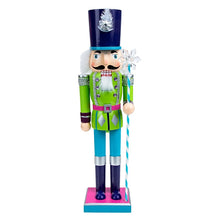 Load image into Gallery viewer, Neon Costume Nutcracker Soldiers by Allthingscurated. These Nutcracker figures sport a psychedelic look with electric shades of Neon Blue, Green and Pink which is a daring and bold twist from the usual classic-style Nutcracker design. Their eye-catching colors and design will create a show-stopping look for your Christmas decor, making it truly unforgettable. Featured here is the Neon Green Soldier.