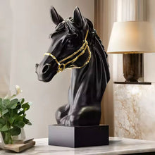 Load image into Gallery viewer, Black horse head sculpture with gold bridle on a table next to a lamp and plant. Fargo Horse Head Bust by Allthingscurated is an elegant decorative sculpture with meticulous detail and flaunts a gorgeous gold-accented bridle. Perfect for horse enthusiasts and makes a meaningful gift for those born under the Horse zodiac sign. And expertly crafted to complement both timeless classic and contemporary modern interiors.