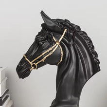 Load image into Gallery viewer, Black horse head sculpture with gold bridle on a light gray background. Fargo Horse Head Bust by Allthingscurated is an elegant decorative sculpture with meticulous detail and flaunts a gorgeous gold-accented bridle. Perfect for horse enthusiasts and makes a meaningful gift for those born under the Horse zodiac sign. And expertly crafted to complement both timeless classic and contemporary modern interiors.