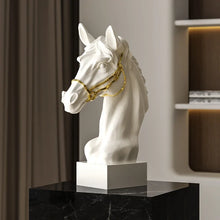 Load image into Gallery viewer, White horse head sculpture with gold bridle on a black marble surface. Fargo Horse Head Bust by Allthingscurated is an elegant decorative sculpture with meticulous detail and flaunts a gorgeous gold-accented bridle. Perfect for horse enthusiasts and makes a meaningful gift for those born under the Horse zodiac sign. And expertly crafted to complement both timeless classic and contemporary modern interiors.