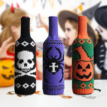 Load image into Gallery viewer, Halloween Knitted Wine Bottle Sleeves by Allthingscurated come in 3 trendy design of a skull, spider and pumpkin. They are are great way to dress up your wine bottles for quick Halloween makeover for your home and dining table.