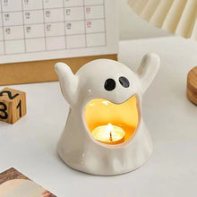 Load image into Gallery viewer, Happy Ghost Candle Holder by Allthingscurated is made from high-quality porcelain with a cute ghost design. Perfect for holding tealight candles. Group several holders together to create a cozy and fun atmosphere during Halloween.