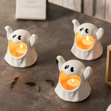Load image into Gallery viewer, Happy Ghost Candle Holder by Allthingscurated is made from high-quality porcelain with a cute ghost design. Perfect for holding tealight candles. Group several holders together to create a cozy and fun atmosphere during Halloween.