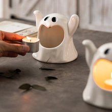 Load image into Gallery viewer, Happy Ghost Candle Holder by Allthingscurated is made from high-quality porcelain with a cute ghost design. Perfect for holding tealight candles. Group several holders together to create a cozy and fun atmosphere during Halloween.