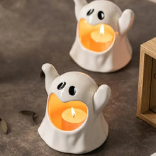 Load image into Gallery viewer, Happy Ghost Candle Holder by Allthingscurated is made from high-quality porcelain with a cute ghost design. Perfect for holding tealight candles. Group several holders together to create a cozy and fun atmosphere during Halloween.