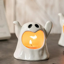 Load image into Gallery viewer, Happy Ghost Candle Holder by Allthingscurated is made from high-quality porcelain with a cute ghost design. Perfect for holding tealight candles. Group several holders together to create a cozy and fun atmosphere during Halloween.