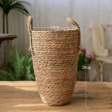 Load image into Gallery viewer, Hayden Tall Planters by Allthingscurated come in 3 sizes. Hand-woven using natural seagrass and comes with handles for easy transportation. Featured here is a small size planter measuring height of 29cm or 11.3 inches and diameter of 19cm or 7.4 inches.