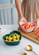 Load image into Gallery viewer, Heart-shaped teal bowl with fruit and a pink bowl with grapefruit slices on a table. Gold-rimmed Heart Shape Ceramic Bowl by Allthingscurated is a beautiful and versatile piece to own in your dinnerware collection. Perfect for salads, desserts and appetizers, its charming design adds an extra touch of romance for Valentine’s Day dinner; and make everyday meals extra special.