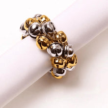 Load image into Gallery viewer, Jingle Bells Napkin Rings by Allthingscurated. Come as a set of 6 rings in color combos of red and green, or silver and gold, they are the perfect finishing touch for your holiday table setting. Spread the joy of Christmas and charm your guests with the cheerful bells. Featured here is the Silver Gold color combo.