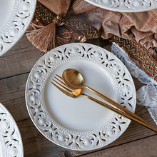 Load image into Gallery viewer, Juliette White Lace Dinnerware by Allthingscurated adds an elegant touch to your tabletop. This sophisticated set is crafted out of ceramic with a beautiful embossed lace rim, giving it a vintage touch. The creamy white pieces come in a dinner plate and cake stand in 2 sizes for easy mixing and matching. They are perfectly sized for a main course, starters and desserts.