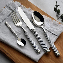 Load image into Gallery viewer, Julius Silver Stainless Steel Flatware Sets by Allthingscurated are crafted from high-quality 18/10 stainless steel. The weighty and solid construction provides a luxurious feel, while the Roman column handle design adds a touch of elegance. The mirror polished surface reflects a bright and shiny finish, adding a touch of sophistication to any table.