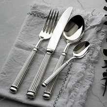 Load image into Gallery viewer, Julius Silver Stainless Steel Flatware Sets by Allthingscurated are crafted from high-quality 18/10 stainless steel. The weighty and solid construction provides a luxurious feel, while the Roman column handle design adds a touch of elegance. The mirror polished surface reflects a bright and shiny finish, adding a touch of sophistication to any table.
