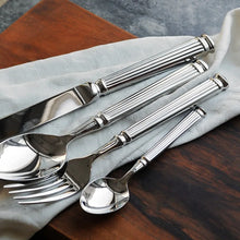 Load image into Gallery viewer, Julius Silver Stainless Steel Flatware Sets by Allthingscurated are crafted from high-quality 18/10 stainless steel. The weighty and solid construction provides a luxurious feel, while the Roman column handle design adds a touch of elegance. The mirror polished surface reflects a bright and shiny finish, adding a touch of sophistication to any table.