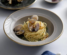 Load image into Gallery viewer, Kovan Ceramic Pasta/Soup Bowl by Allthingscurated is a stylish and functional bowl that offers versatility and practicality in usage. Perfectly sized for pasta, soups, stews, desserts and more. It’s a must-have addition to your dinnerware collection for all occasions from formal dining to everyday casual meals. Comes in gray and black.