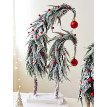 Load image into Gallery viewer, Snow Flocked Grinch Christmas Trees by Allthingscurated feature bending trees with a touch of quirkiness. The abstract design is both unconventional and whimsical. These snow-covered trees are decorated with crimson red baubles that will transform your home into a winter wonderland. Available in 2 sizes.