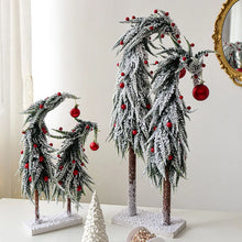 Load image into Gallery viewer, Snow Flocked Grinch Christmas Trees by Allthingscurated feature bending trees with a touch of quirkiness. The abstract design is both unconventional and whimsical. These snow-covered trees are decorated with crimson red baubles that will transform your home into a winter wonderland. Available in 2 sizes.