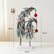 Load image into Gallery viewer, Snow Flocked Grinch Christmas Trees by Allthingscurated feature bending trees with a touch of quirkiness. The abstract design is both unconventional and whimsical. These snow-covered trees are decorated with crimson red baubles that will transform your home into a winter wonderland. Available in 2 sizes. Featured here is the Large set.