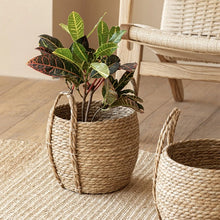 Load image into Gallery viewer, Leedon Woven Baskets by Allthingscurated are hand-woven from seagrass which is an eco-friendly material. The baskets feature sturdy handles for easy transportation and lend a rustic charm to any space. Perfect for storing household items or displaying your favorite plants. Available in 3 sizes.