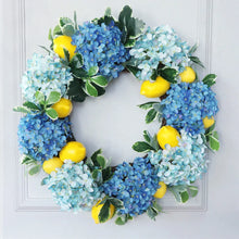 Load image into Gallery viewer, Summer Lemon Hydrangea wreath by Allthingscurated features a vibrant and cheerful yellow and blue color scheme, evoking images of sunny blue skies and warm summer days. The wreath adds a pop of color to your door and bring a little extra happiness to your home.