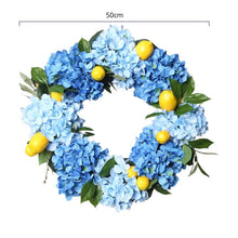 Load image into Gallery viewer, Summer Lemon Hydrangea wreath by Allthingscurated features a vibrant and cheerful yellow and blue color scheme, evoking images of sunny blue skies and warm summer days. The wreath adds a pop of color to your door and bring a little extra happiness to your home. Measures approximately 50cm or 19.7 inches in diameter.
