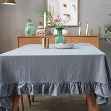 Load image into Gallery viewer, Introducing Ruffled Cotton Tablecloth by Allthingscurated. Made from 100% cotton, our tablecloth exudes French country charm with its romantic, frilly ruffles. With the perfect balance of decorative and laid-back, they have a welcoming and comforting vibe. Available in 8 solid colors. Featured here is the Light Gray tablecloth.