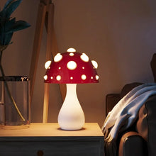 Load image into Gallery viewer, Whimsical Mushroom LED Lamp by Allthingscurated is unique and decorative, yet functional. The enchanting design features a playful mushroom silhouette, complete with red-capped spots lampshade to bring a touch of whimsy to any room. It makes a perfect gift for someone with a special affinity for mushrooms. Comes in a cordless and corded version with 2 lamp base colors.