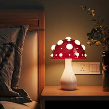 Load image into Gallery viewer, Whimsical Mushroom LED Lamp by Allthingscurated is unique and decorative, yet functional. The enchanting design features a playful mushroom silhouette, complete with red-capped spots lampshade to bring a touch of whimsy to any room. It makes a perfect gift for someone with a special affinity for mushrooms. Comes in a cordless and corded version with 2 lamp base colors.