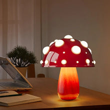 Load image into Gallery viewer, Whimsical Mushroom LED Lamp by Allthingscurated is unique and decorative, yet functional. The enchanting design features a playful mushroom silhouette, complete with red-capped spots lampshade to bring a touch of whimsy to any room. It makes a perfect gift for someone with a special affinity for mushrooms. Comes in a cordless and corded version with 2 lamp base colors.