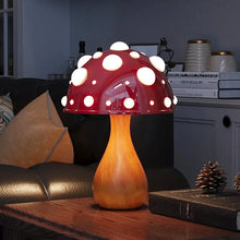 Load image into Gallery viewer, Whimsical Mushroom LED Lamp by Allthingscurated is unique and decorative, yet functional. The enchanting design features a playful mushroom silhouette, complete with red-capped spots lampshade to bring a touch of whimsy to any room. It makes a perfect gift for someone with a special affinity for mushrooms. Comes in a cordless and corded version with 2 lamp base colors.