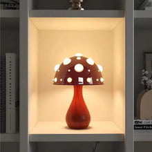 Load image into Gallery viewer, Whimsical Mushroom LED Lamp by Allthingscurated is unique and decorative, yet functional. The enchanting design features a playful mushroom silhouette, complete with red-capped spots lampshade to bring a touch of whimsy to any room. It makes a perfect gift for someone with a special affinity for mushrooms. Comes in a cordless and corded version with 2 lamp base colors.