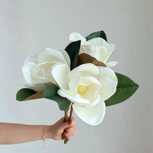 Load image into Gallery viewer, Faux Large White Magnolia by Allthingscurated is expertly crafted with realistic details to look as good as the real thing. It’s a gorgeous addition to your home décor and stays beautiful and pretty all year round. Its grand size makes it perfect as a single flower but creates a dramatic effect when arranged in a bunch. Measures 40cm or 15.6 inches in height and 18cm or 7 inches in width.