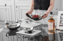 Load image into Gallery viewer, Manhattan Stainless Steel Fruit Bowl by Allthingscurated exudes elegance and modern sophistication. Crafted from high-quality stainless steel and featuring sleek, sexy curve lines with a beautiful mirror polish. Use it to beautifully present your fruits when hosting or give it as a perfect house warming gift. It’s the ultimate statement piece for contemporary homes and stylish décor. Comes in 3 sizes and nests for space-saving storage.