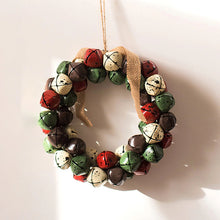 Load image into Gallery viewer, Christmas Jingle Bells Wreath by Allthingscurated comes in 3 semi-matte colors of Red, Multi Colors and Gold. The Multi Color Wreath features clusters of bell in green, red, ivory and brown. Each wreath is formed of bells made of iron entwined onto a jute rope and truly jingle with each movement. Measures approximately 18cm or 7 inches in width and height. This is a Multi Color Wreath.