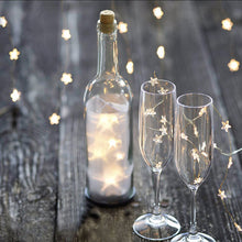 Load image into Gallery viewer, Mini Stars LED Fairy Lights by Althingscurated. Create a cozy and festive atmosphere with these decorative lights that offer a warm, tinkling glow. These mini stars are attached to silver wire that is bendable and easy to manipulate so you can fit them into tiny spaces or wrap around objects to enhance your favorite decorations. Comes in 6 different lengths from 1 meters to 6 meters or 39 to 236 inches. Available in warm white or white lights.