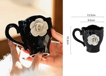 Load image into Gallery viewer, This Camellia Porcelain Cup Set / Mug by Allthingscurated features a single, significant bloom in a timeless black and white design that exudes sophistication. Its high fashion appeal makes it a perfect gift or impressive addition to your high-tea gatherings. Available as a mug or a cup set. Featured here is the Camellia Cup with Saucer set.