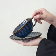 Load image into Gallery viewer, Japanese Chrysanthemum Cup and Saucer by Allthingscurated is inspired by the flower’s perfect symmetry and stunning beauty in the Japanese culture. Crafted from porcelain, it’s a beautiful set to entertain friends and family for afternoon teas at home. This is a Blue cup and saucer set.