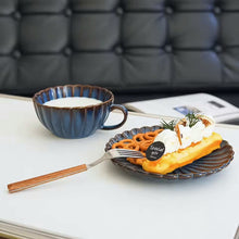 Load image into Gallery viewer, Waffle with whipped cream on a plate with a cup of milk in the background. Japanese Chrysanthemum Cup and Saucer by Allthingscurated is inspired by the flower’s perfect symmetry and stunning beauty in the Japanese culture. Crafted from porcelain, it’s a beautiful set to entertain friends and family for afternoon teas at home.