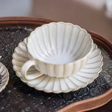 Load image into Gallery viewer, Japanese Chrysanthemum Cup and Saucer by Allthingscurated is inspired by the flower’s perfect symmetry and stunning beauty in the Japanese culture. Crafted from porcelain, it’s a beautiful set to entertain friends and family for afternoon teas at home.