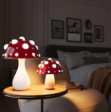 Load image into Gallery viewer, Whimsical Mushroom LED Lamp by Allthingscurated is unique and decorative, yet functional. The enchanting design features a playful mushroom silhouette, complete with red-capped spots lampshade to bring a touch of whimsy to any room. It makes a perfect gift for someone with a special affinity for mushrooms. Comes in a cordless and corded version with 2 lamp base colors.