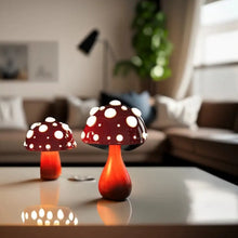 Load image into Gallery viewer, Whimsical Mushroom LED Lamp by Allthingscurated is unique and decorative, yet functional. The enchanting design features a playful mushroom silhouette, complete with red-capped spots lampshade to bring a touch of whimsy to any room. It makes a perfect gift for someone with a special affinity for mushrooms. Comes in a cordless and corded version with 2 lamp base colors.
