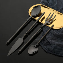Load image into Gallery viewer, Neptune 4-piece Flatware Set by Allthingscurated beautifully blends mythical design with modern construction. Made from high-quality 18/10 stainless steel with a sleek mirror polishing for a modern look. Inspired by Poseidon’s Trident, the dinner fork is expertly shaped to resemble the 3-pronged spear. Unique and elegant, the place setting comes in silver, gold, rose gold, black and colorful rainbow and each set consists of a dinner spoon, dinner fork, dinner knife and a small spoon.
