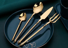 Load image into Gallery viewer, Neptune 4-piece Flatware Set by Allthingscurated beautifully blends mythical design with modern construction. Made from high-quality 18/10 stainless steel with a sleek mirror polishing for a modern look. Inspired by Poseidon’s Trident, the dinner fork is expertly shaped to resemble the 3-pronged spear. Unique and elegant, the place setting comes in silver, gold, rose gold, black and colorful rainbow and each set consists of a dinner spoon, dinner fork, dinner knife and a small spoon.