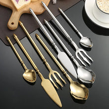 Load image into Gallery viewer, Neptune 4-piece Flatware Set by Allthingscurated beautifully blends mythical design with modern construction. Made from high-quality 18/10 stainless steel with a sleek mirror polishing for a modern look. Inspired by Poseidon’s Trident, the dinner fork is expertly shaped to resemble the 3-pronged spear. Unique and elegant, the place setting comes in silver, gold, rose gold, black and colorful rainbow and each set consists of a dinner spoon, dinner fork, dinner knife and a small spoon.